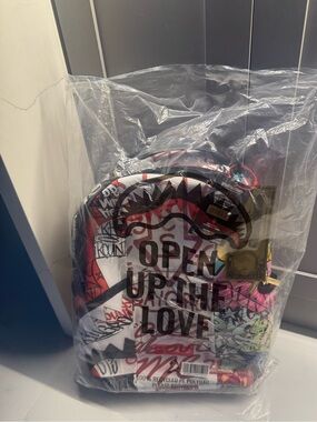 Sprayground Colorful Graffiti Sling Backpack in Red, Yellow, Pink, Black